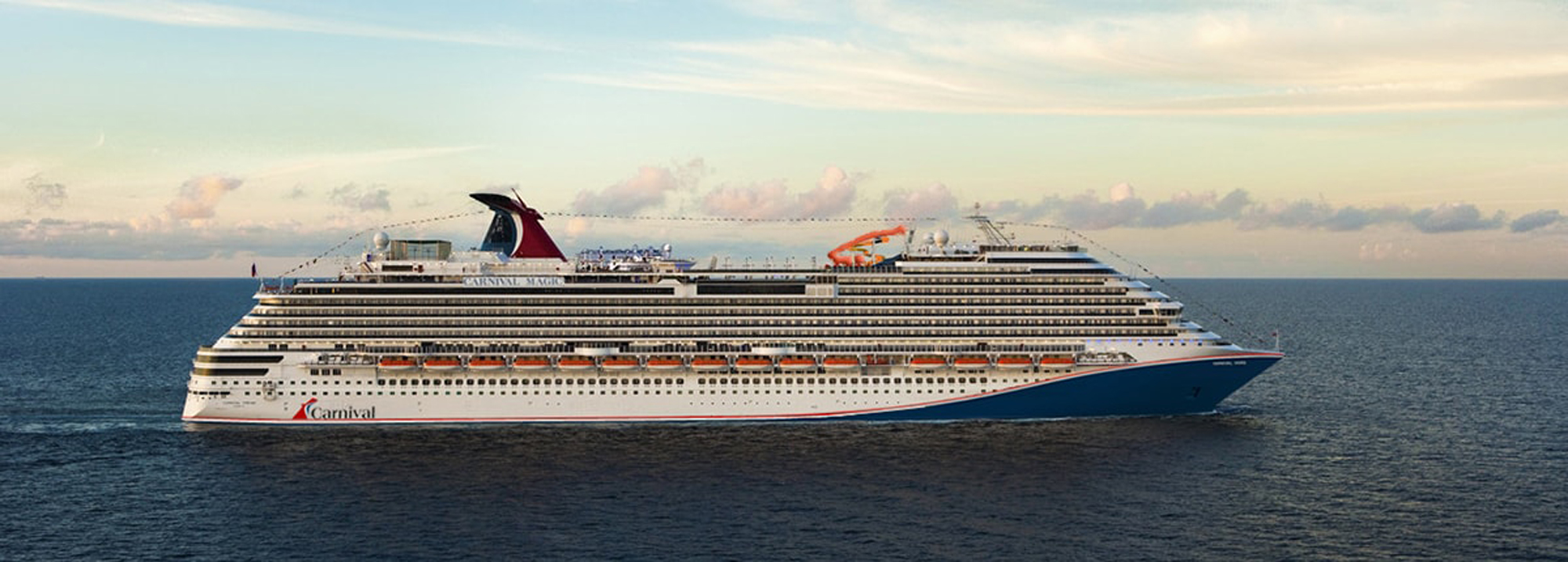 Carnival Cruise Ship on Open Ocean A large Carnival cruise ship sailing across a calm blue sea under a soft, cloudy sky during golden