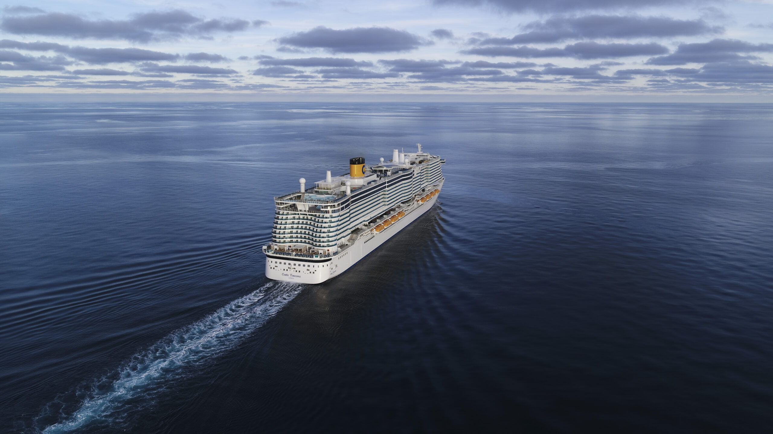 Cruise Ship Sailing on Calm Blue Ocean A large modern cruise ship sailing across a serene, expansive ocean under a cloudy sky.