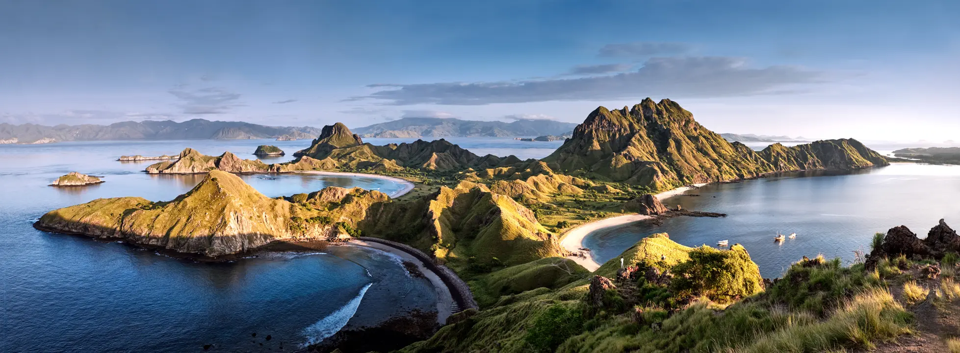 Komodo Islands Volcanic Peaks and Beaches A stunning aerial view of the Komodo Islands in Indonesia, showcasing dramatic volcanic peaks