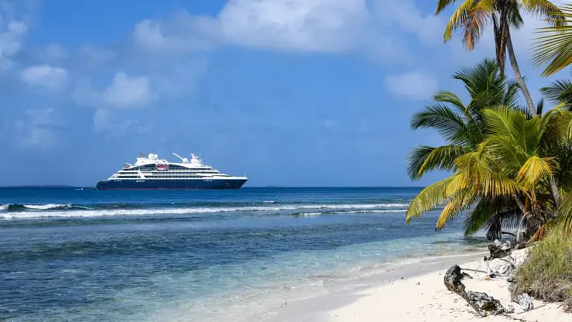 Luxury Cruise Ship by Tropical Beach A sleek modern cruise ship anchored near a pristine white sandy beach with palm trees, showcasing crystal clear blue waters and a tropical paradise setting.