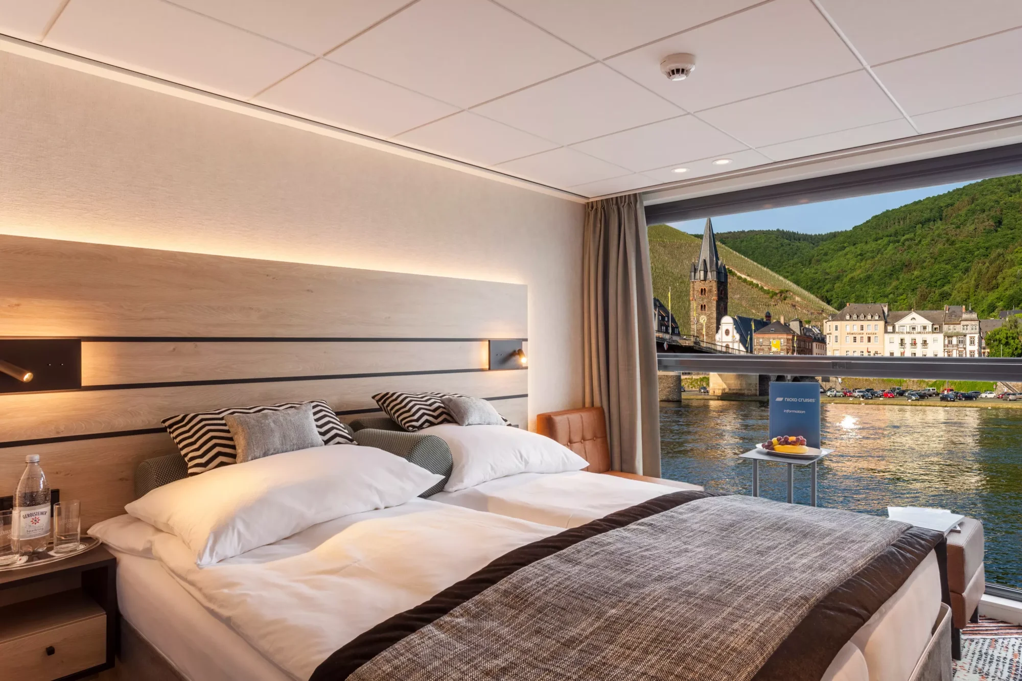 Luxury River Cruise Cabin with Rhine Valley View A sophisticated river cruise cabin featuring a modern bedroom with panoramic floor-to-ceiling