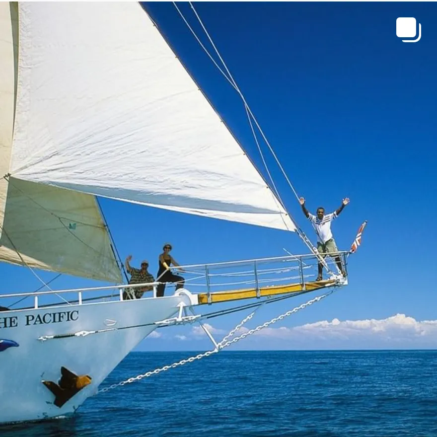 Sailing Adventure on The Pacific A vibrant sailing experience aboard The Pacific with passengers enjoying the open ocean under