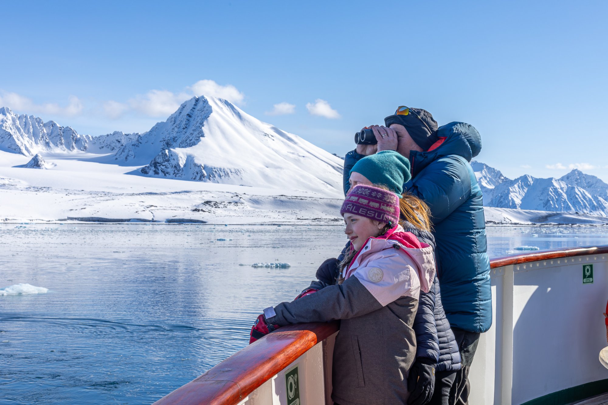 Svalbard adventure expedition with Hurtigruten cruise ship in Arctic waters surrounded by glacial landscapes.