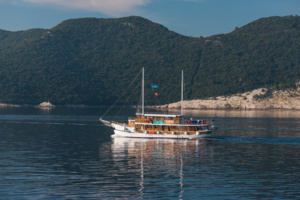 Traditional Gulet Sailing in Turkish Waters A classic wooden gulet sailing vessel with traditional Turkish design anchors in calm