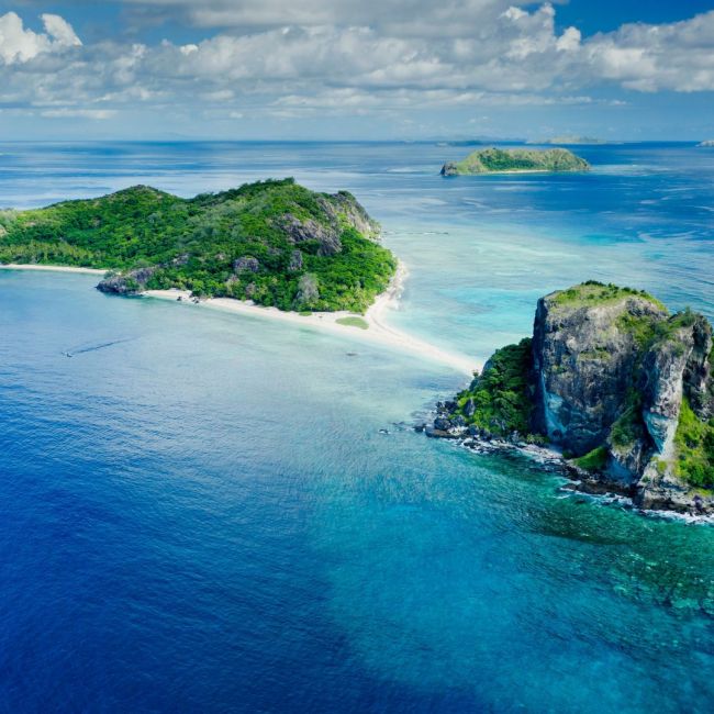 Tropical Islands with White Sand Beach A stunning aerial view of pristine tropical islands featuring white sand beaches, lush green