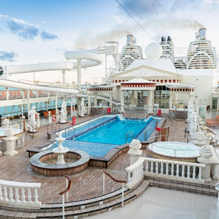 Luxurious Pool Deck on Modern Cruise Ship An expansive cruise ship pool deck featuring a large turquoise swimming pool, hot tubs, water