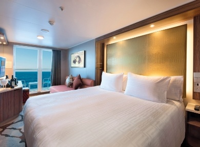 Luxury Cruise Ship Oceanview Cabin with Balcony A luxury cruise ship oceanview cabin with balcony, featuring modern furnishings and ocean views through floor-to-ceiling windows.