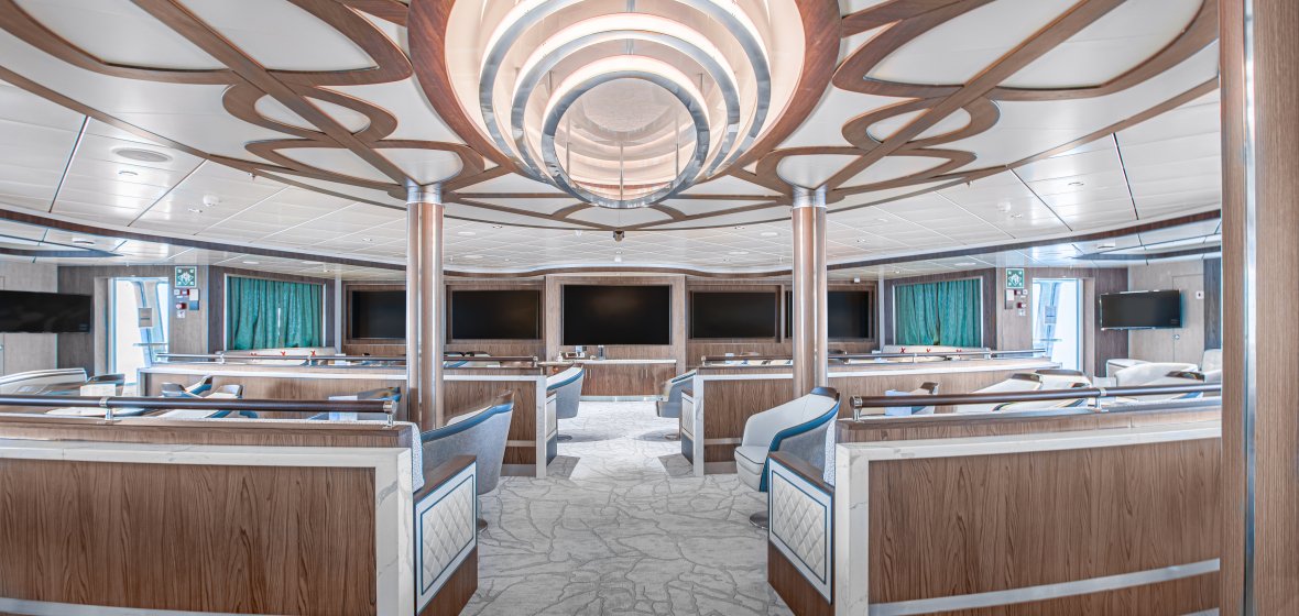 Modern Lecture Room with Circular Ceiling Design A sophisticated lecture room or auditorium featuring a striking circular tiered ceiling with wood